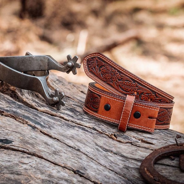 A brown full grain leather belt for women featuring tooled floral pattern 